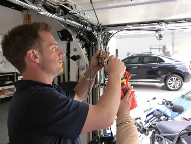 Warren Garage Door Repair safety certified technician performing cable replacement in Warren